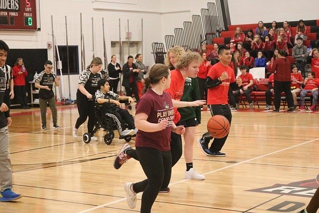 An Ocean City Unified Sports basketball team player dribbles the ball down court.