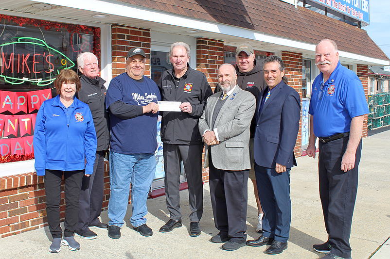 Mike Monichetti, third from left, accepts a check for $10,000 for the Mike’s Seafood Run-Walk for Autism from VFW Commander Joe McLenaghan. (Photo courtesy of Sea Isle City)