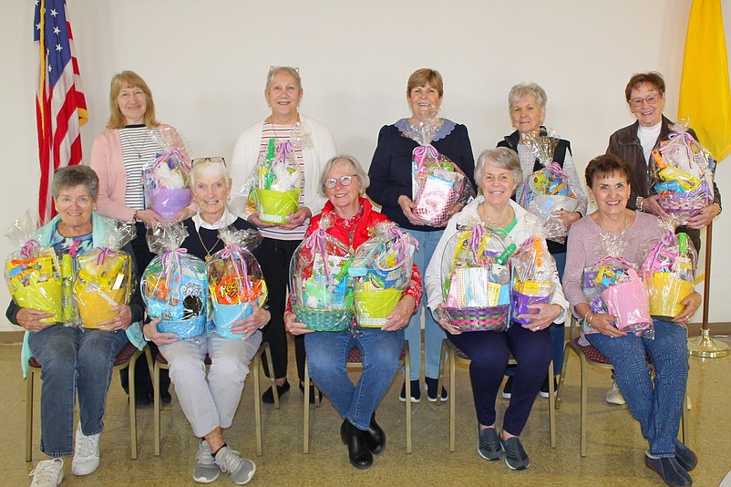 Catholic Daughters show off the Easter baskets filled with candy, toys and other holiday items.