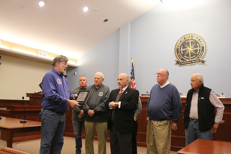 Floodplain Manager Neil Byrne, left, presents Mayor Leonard Desiderio and members of City Council with a plaque recognizing Sea Isle's flood-mitigation efforts.