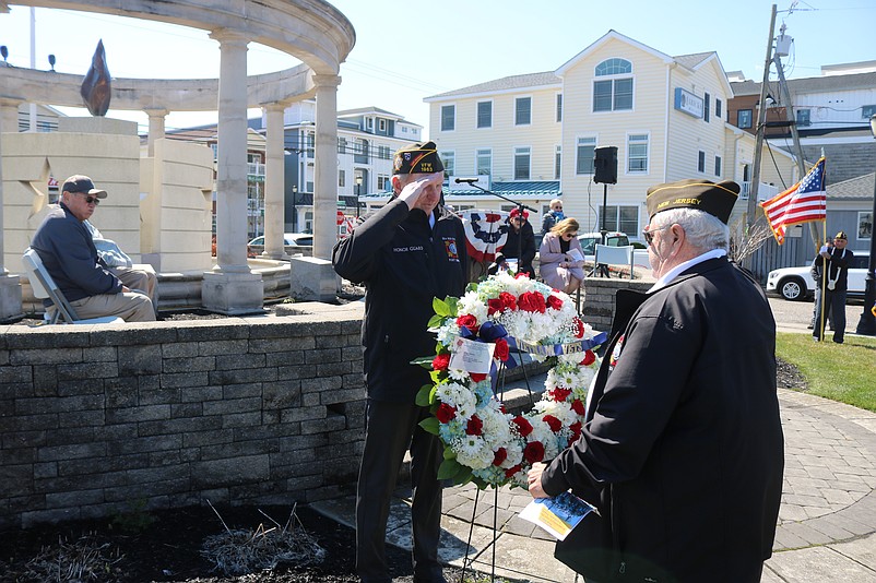 VFW Post 1963 Commander Joe McLenaghan, left, exchanges a salute with fellow veteran John Felicetti during a wreath-laying ceremony.