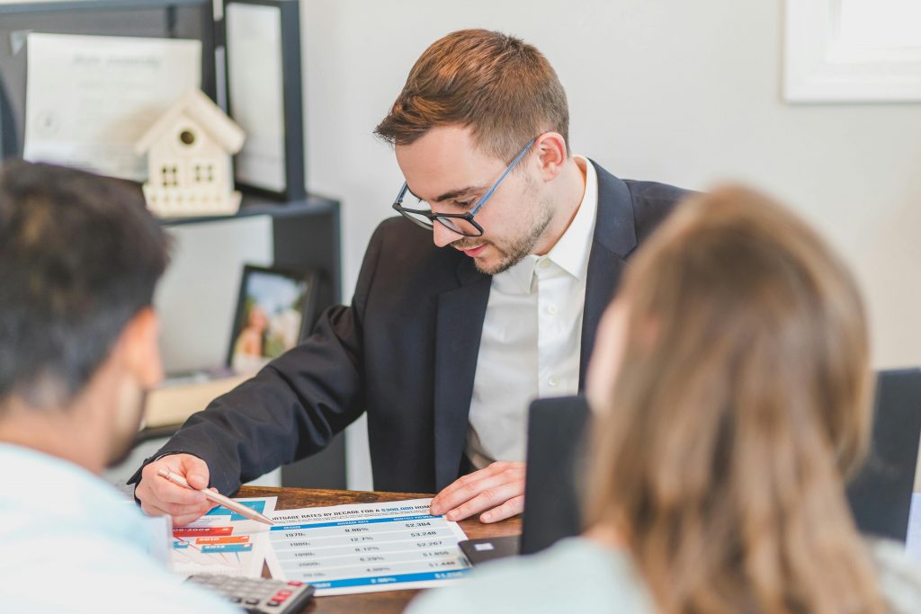 A real estate agent talking with their clients.