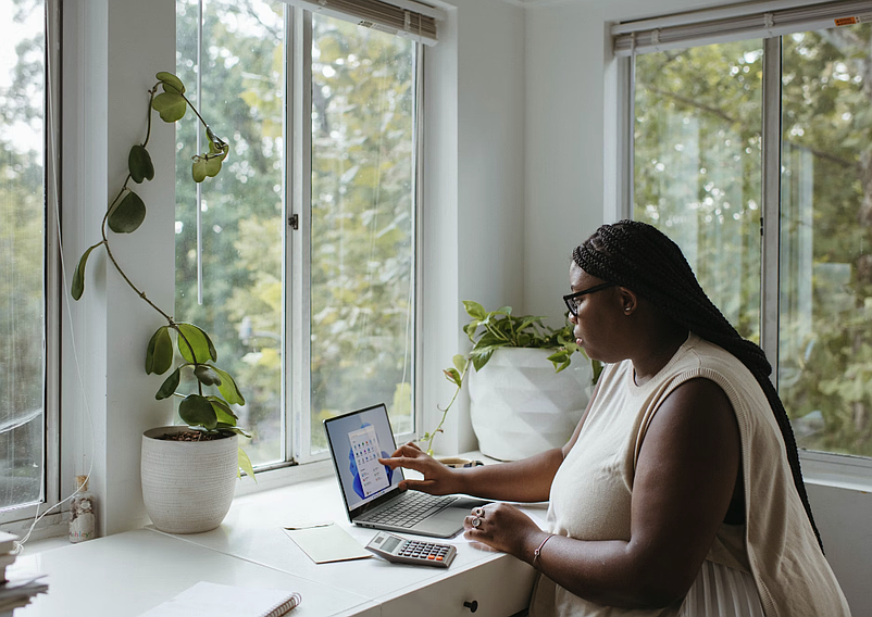 Image source - https://unsplash.com/photos/a-woman-sitting-at-a-table-with-a-laptop-YzLMmxDTrvI 