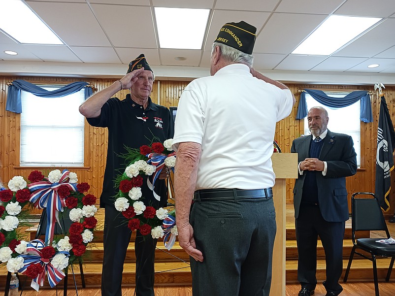 VFW Post 1963 Commander Joe McLenaghan exchanges a salute with Harry Strack during the presentation of a memorial wreath in the 2024 Memorial Day ceremony.
