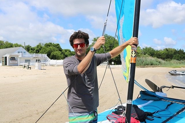 Tyler Myers teaches students to sail from a beach in Beesley's Point.