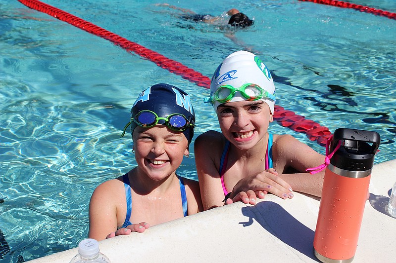 Swimmers Erin Lowry and Adrian Sykes, both 8 and of Linwood, took a break from swimming laps during the annual swim.