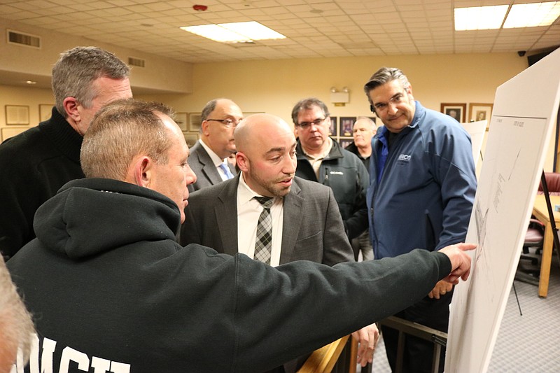 Drew Fasy, co-chair of the bicycle advocacy group Bike OCNJ, points to an area as JMT design company senior associate James Carr (tie) answers his questions.