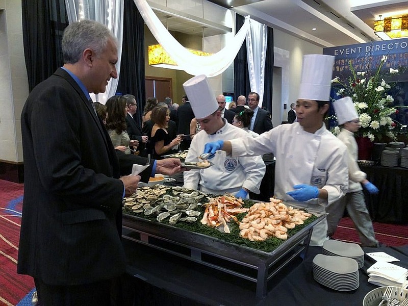 Student chefs Gregory Zervas of Wildwood and Jamie Paguio of Mays Landing serve up some seafood at the gala in 2018.