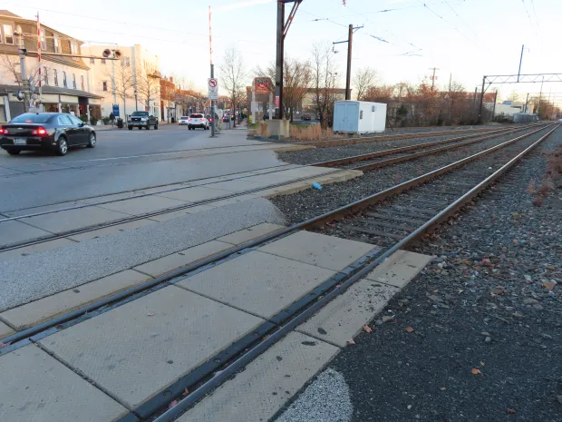 Traffic passes the rail crossing on Main Street in Lansdale in 2021, where new striping and sidewalks are proposed as the first phase of the borough's East Main Streetscape project. (Dan Sokil - MediaNews Group)