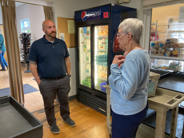 Weisenborn talks with Brandon Trombetta, Executive Director of the Keystone Opportunity Center, in the food pantry. (John Worthington - MediaNews Group)