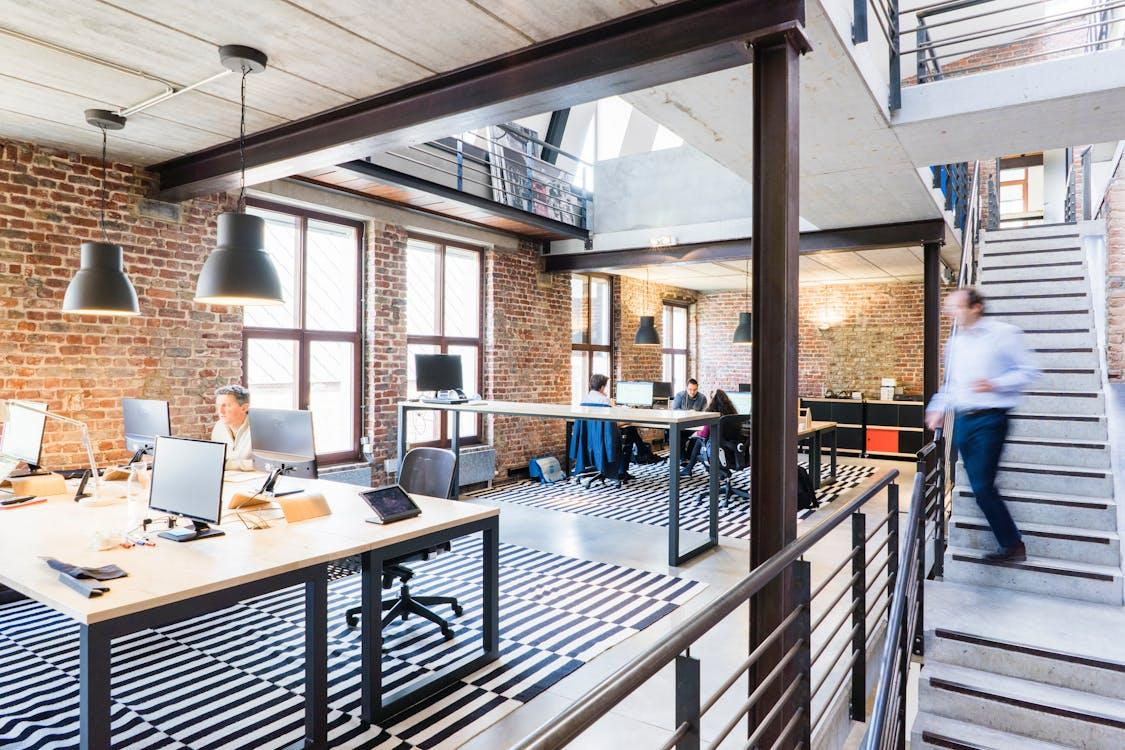 Free Spacious and stylish open-plan office with loft and industrial aesthetic. Stock Photo