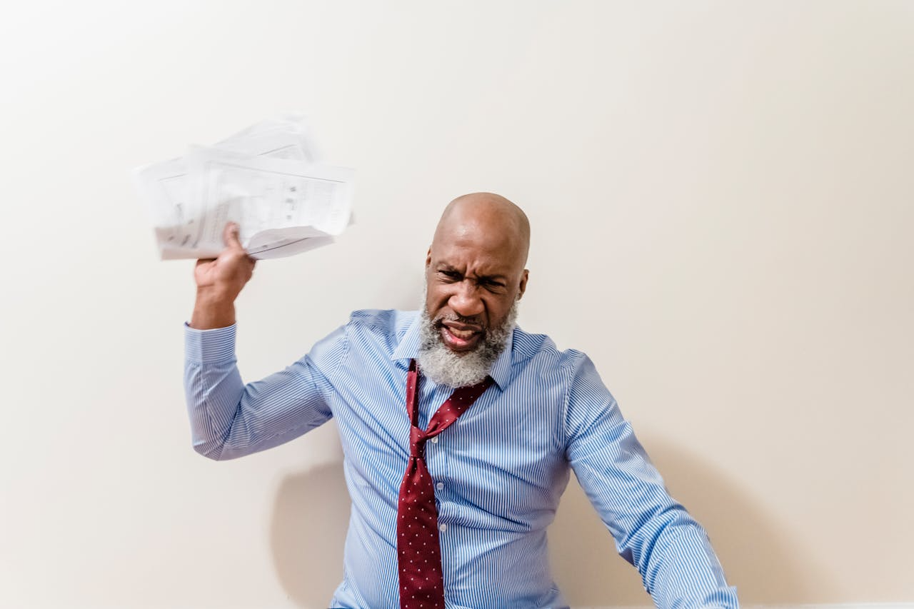 Tenant in Blue Shirt Throwing Documents Away