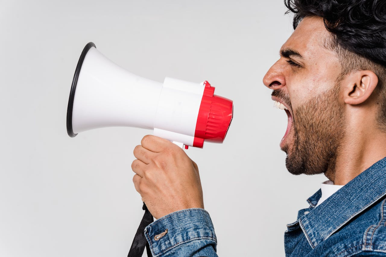 Man Screaming Into A Megaphone