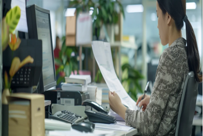 Businesswoman reviews documents to send to fax programs