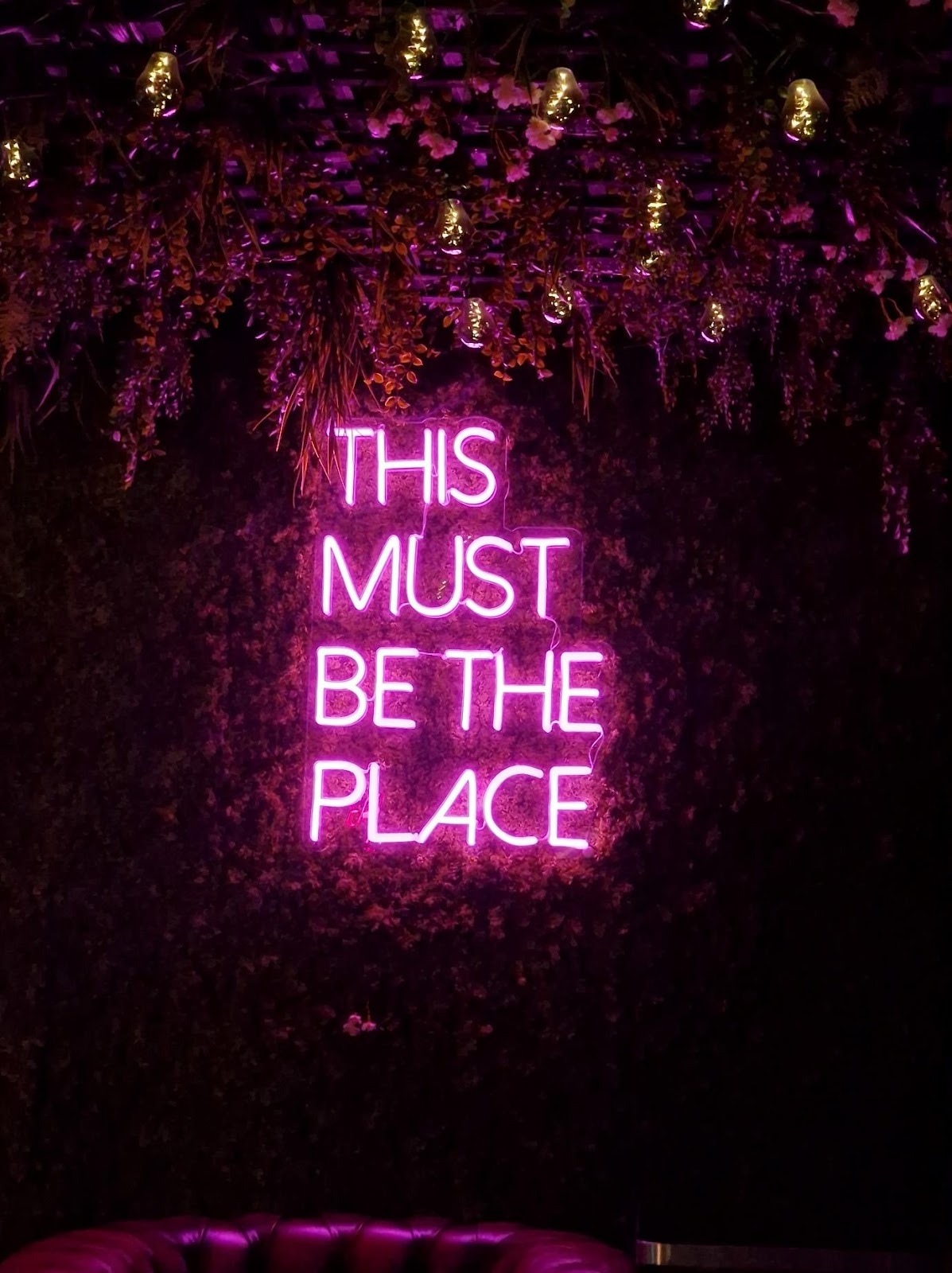 A sign with purple lights

AI-generated content may be incorrect.