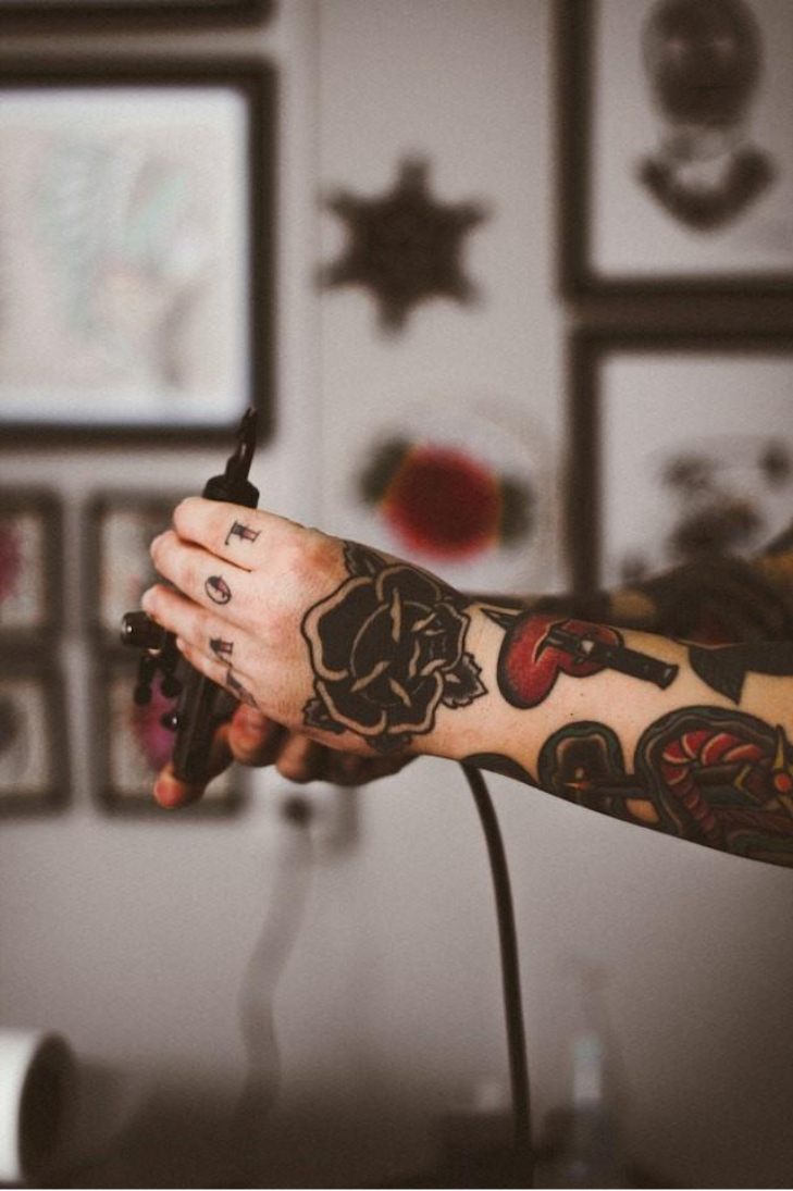 Tattoo artist using digital tools