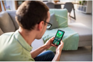 Photo of a Person Placing Sports Bets on his Phone