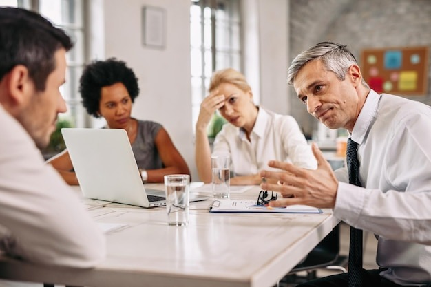 angry businessman discussing with colleague during a meeting in the office