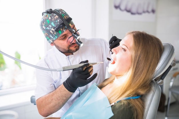dentist doing dental treatment on female patient