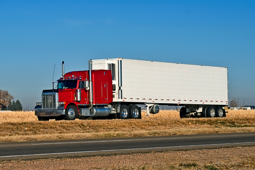 A red semi truck on the road

AI-generated content may be incorrect.