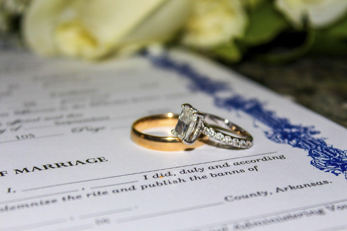 wedding rings on marriage license document